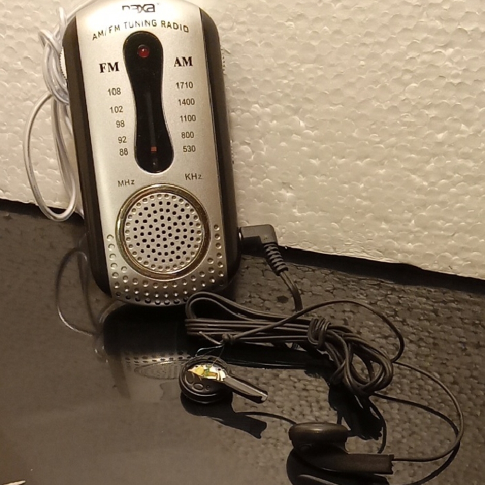 Small radio about 3  1/2 inches. New with no tag stepped on the earphones. Am/Fm